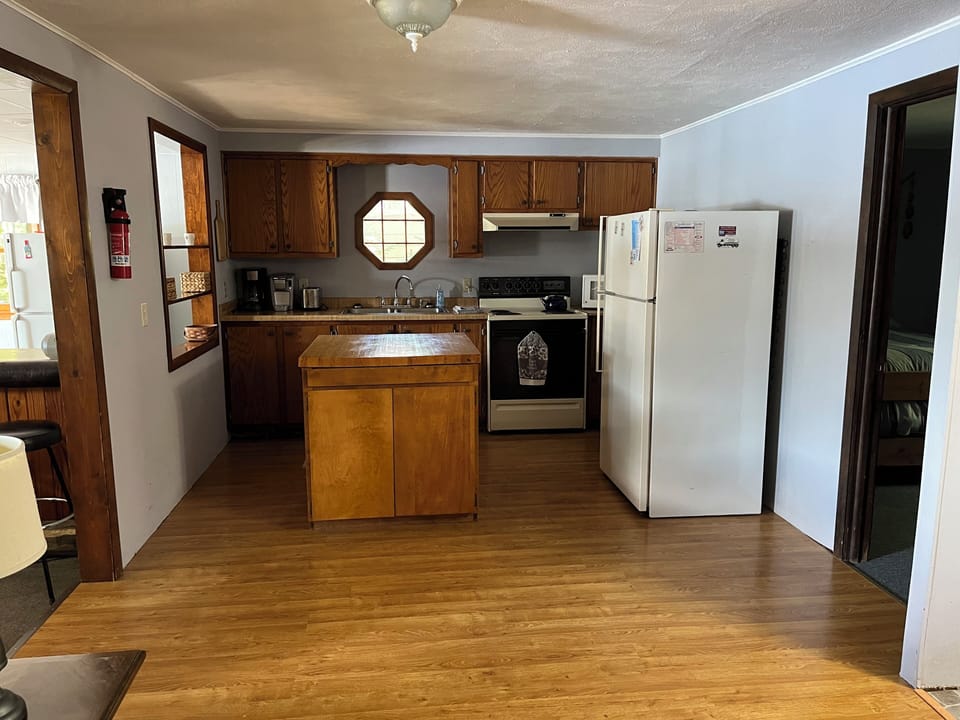 Kitchen area ,door on the right goes to 2nd bedroom , to the left is the bar