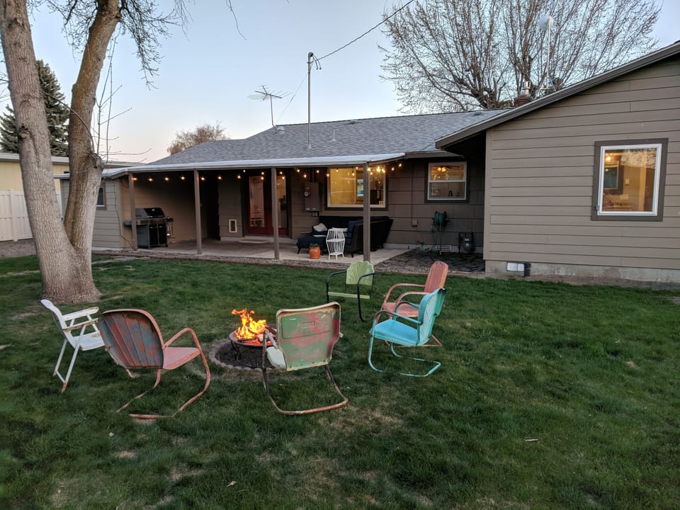Back yard, fire pit area with lots of chairs, more than pictured.