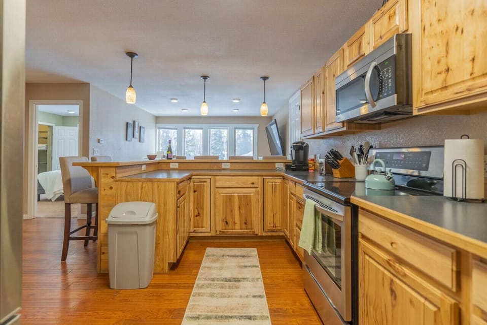 Full Kitchen Looking Towards Breakfast Bar and Living Room
