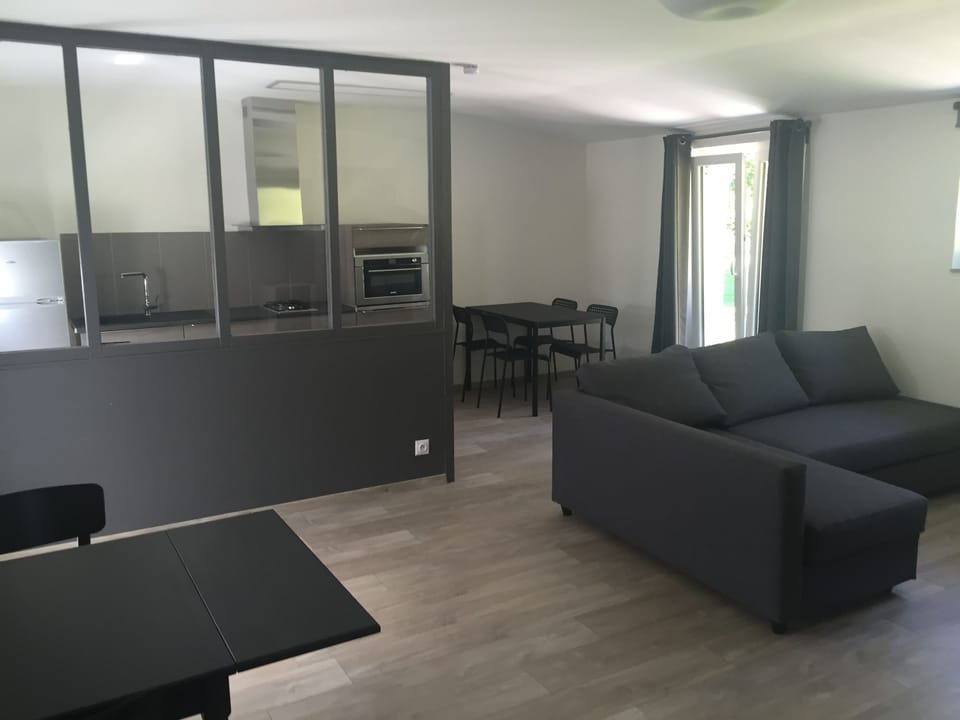 Classic Studio, Garden View | Living area | Flat-screen TV