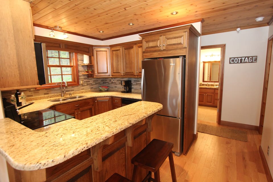 Breakfast counter and kitchen with bar stools to enjoy that glass of wine at.