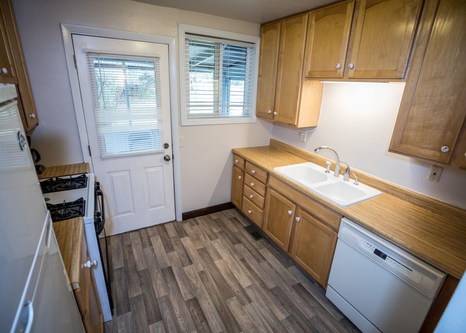 Kitchen with double sink and dishwasher, New Gas Grill out the  back door