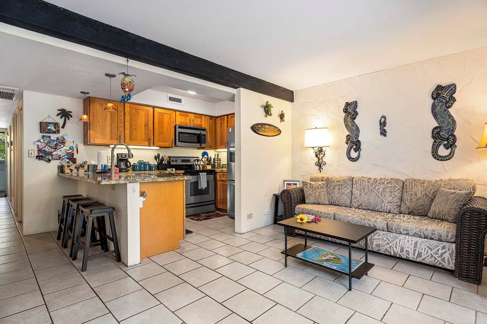 Living room with couch and kitchen in background