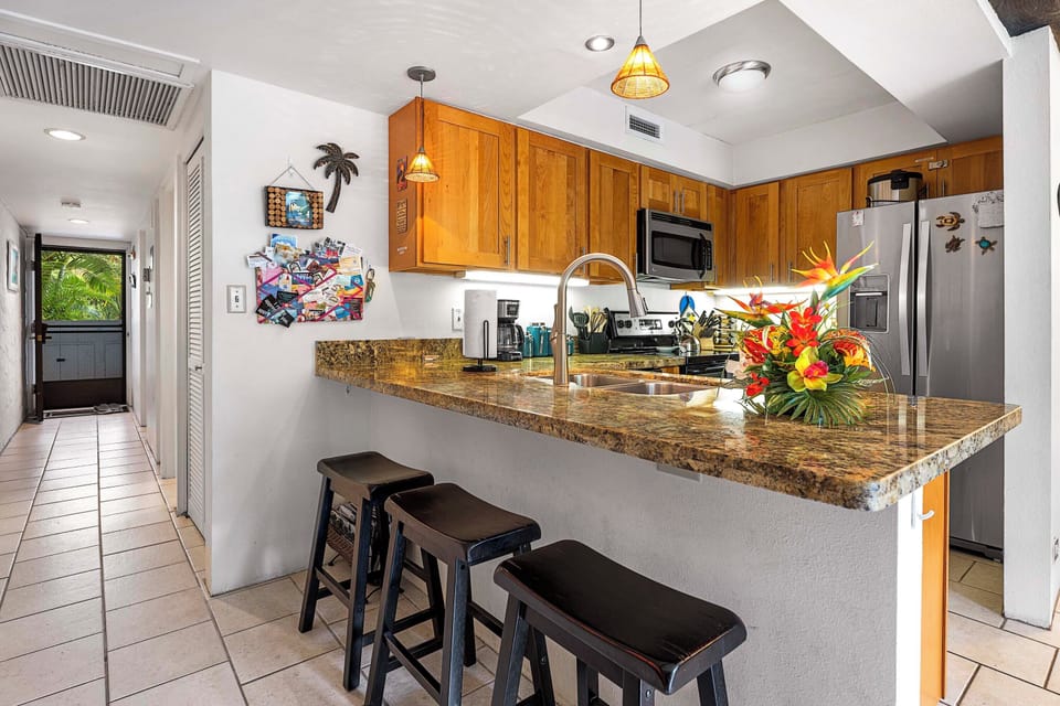 Kitchen with island and refrigerator.