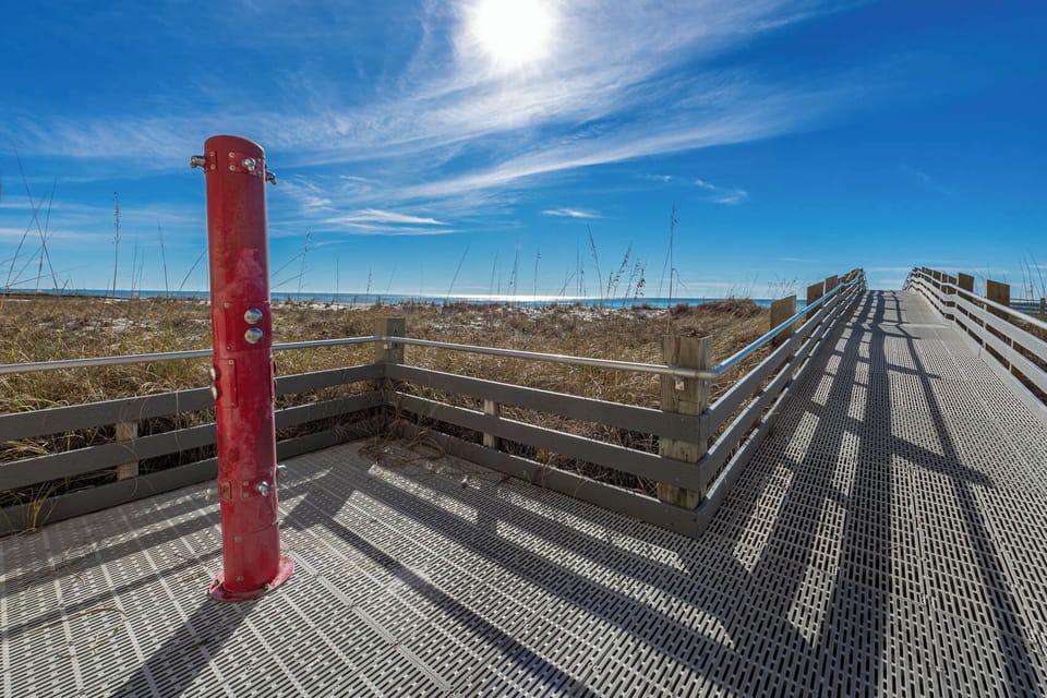 Stroll along the boardwalk at Phoenix III for a day at the beach and rinse the sand at the shower area on your next vacation