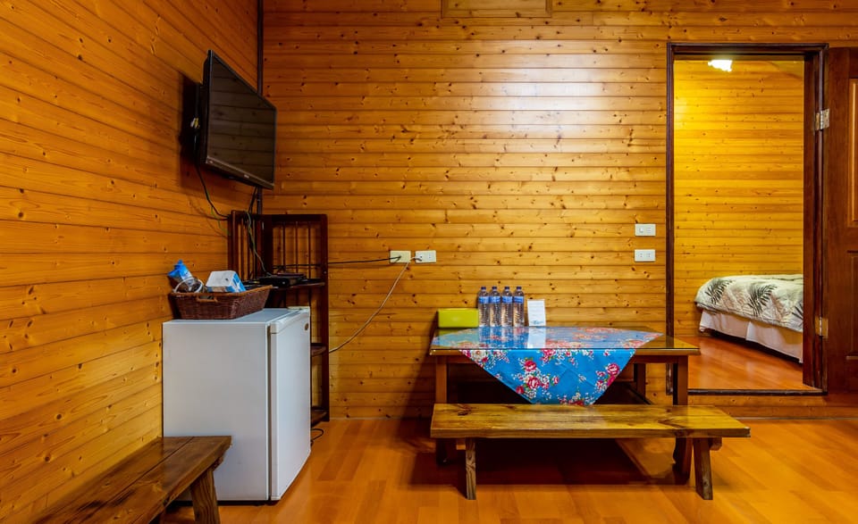 Deluxe Quadruple Room | Living area | 42-inch flat-screen TV with cable channels, TV