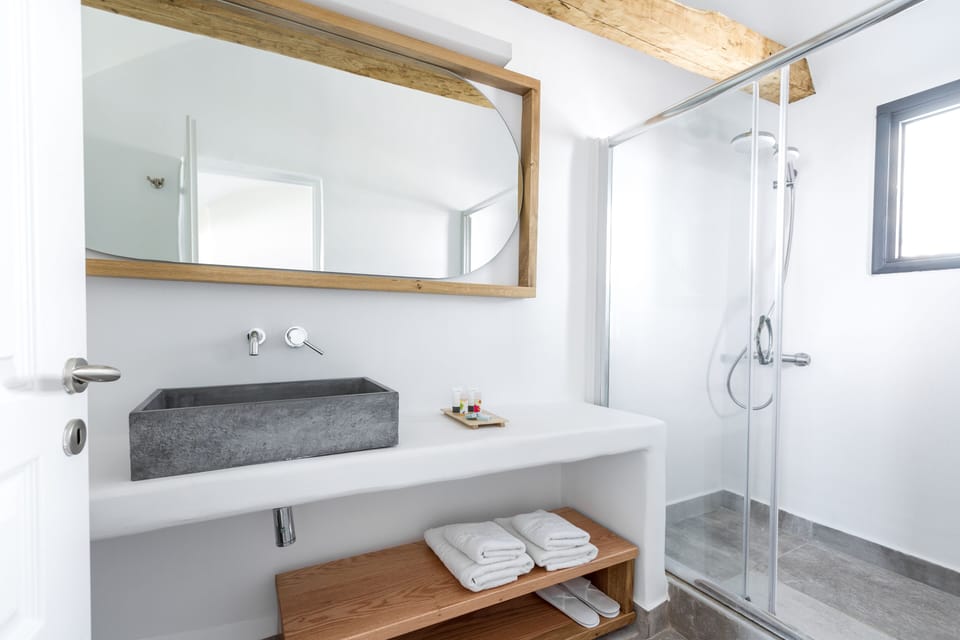 Honeymoon Suite with Private Outdoor Heated Plunge Pool and Caldera view | Bathroom | Shower, rainfall showerhead, designer toiletries, hair dryer