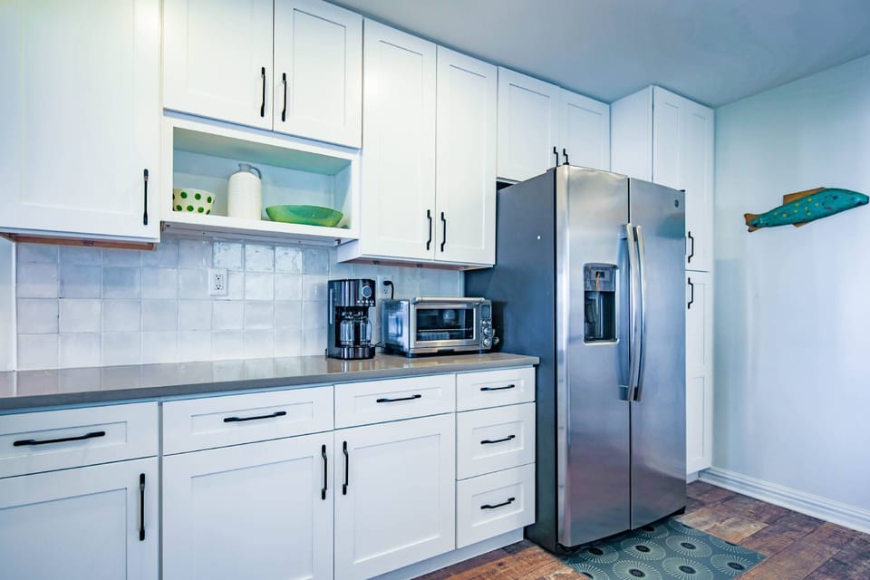 The kitchen also features refrigerator, toaster oven and drip coffee maker.