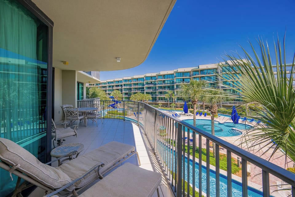 Bask in the warmth while lounging on the balcony, taking in the coastal vibe and vibrant pool area below