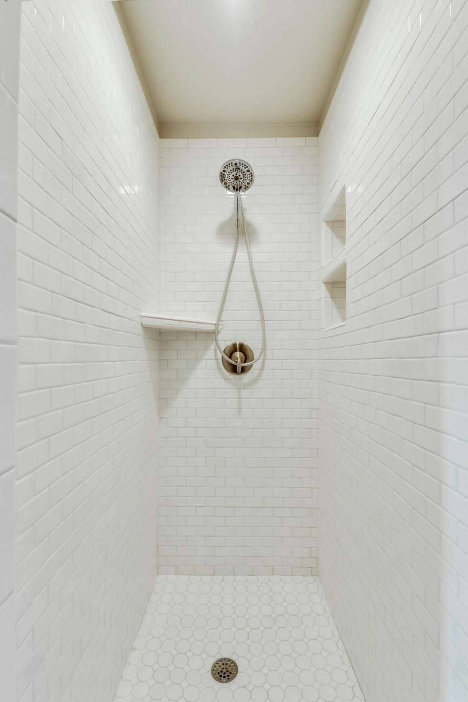 Second bath also has a walk-in, white subway tile shower. 