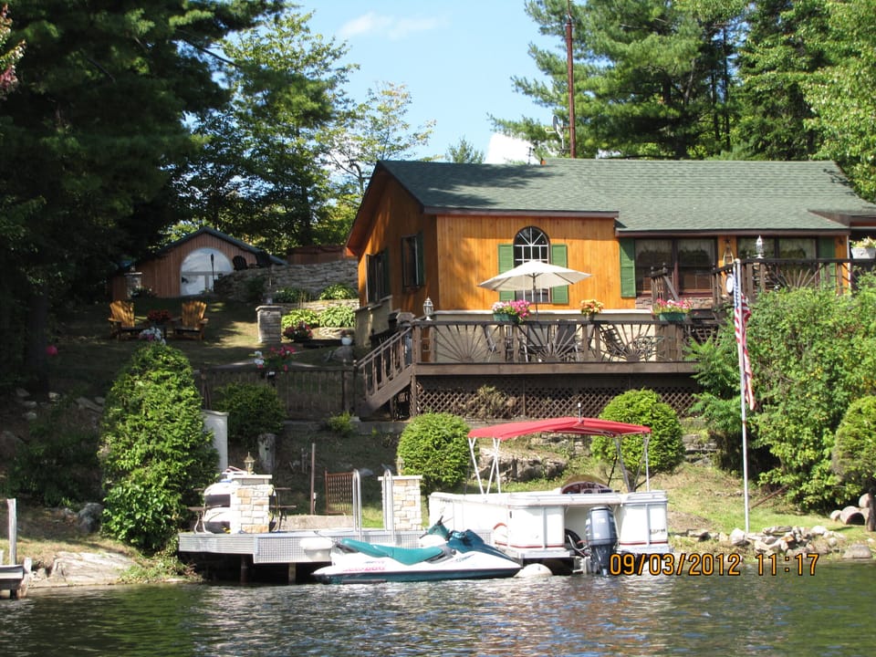 Cottage as viewed from the lake w/bunk house in rear left. Pontoon NOT INCLUDED 