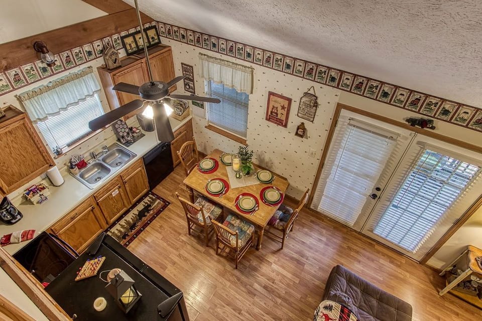 Aerial view of kitchen/eating area and french door leading to the screened porch
