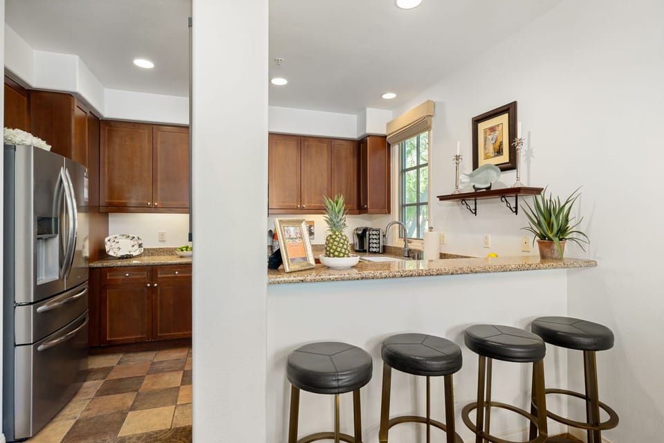 Stylish kitchen with granite countertops and a cozy breakfast bar—seating for 4
