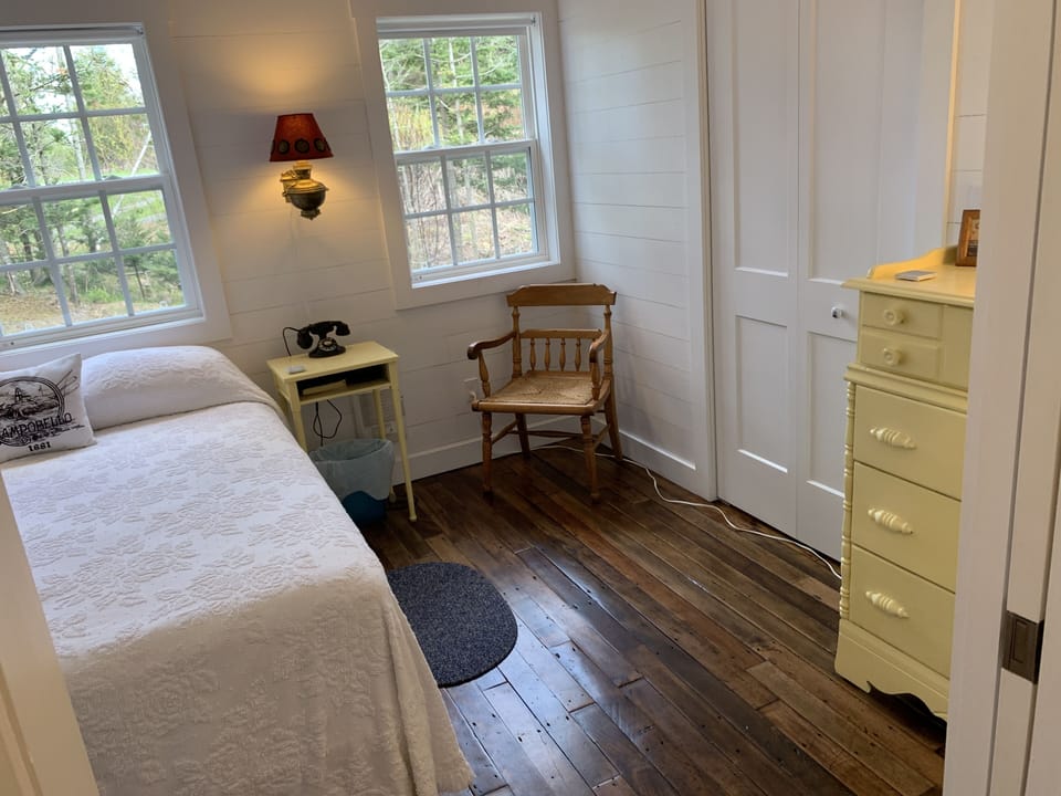 Main bedroom with queen bed and antique maple floors