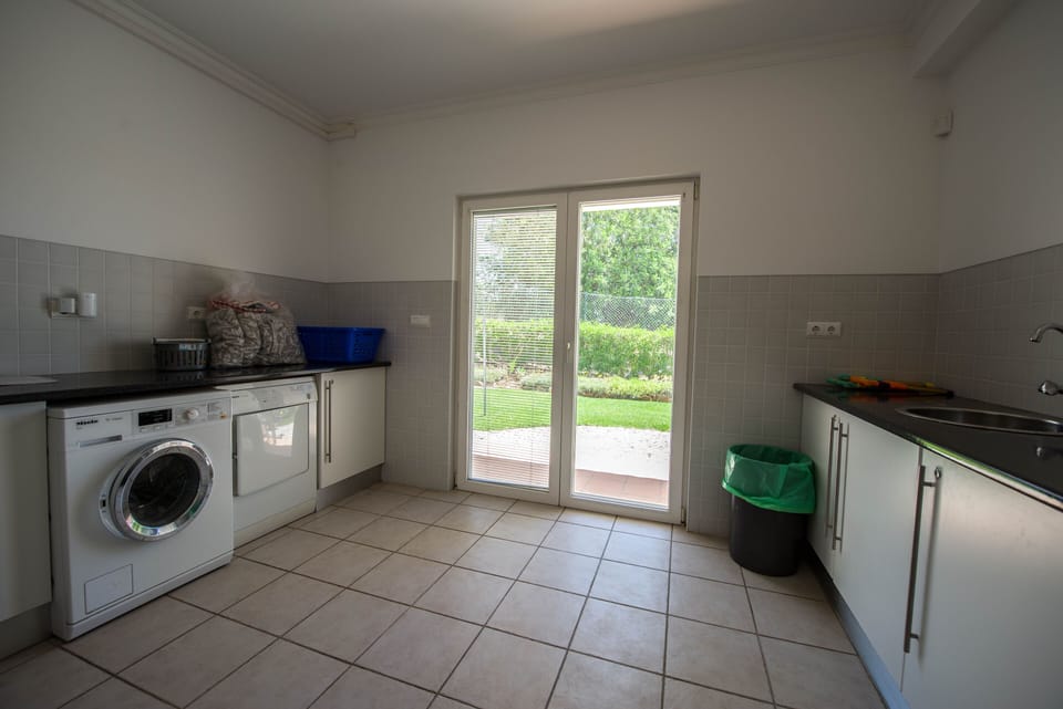 Separate Utility room with Miele washing machine and dryer