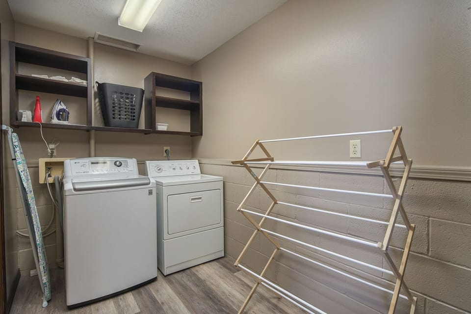 Washer and dryer, iron and ironing board, and drying rack are available.