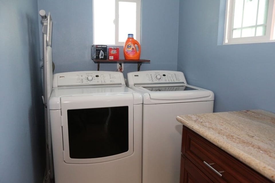 Laundry room with detergent, storage cabinet, iron board with iron