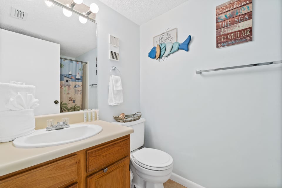 Guest bathroom with a shower/tub combo and a single vanity. 