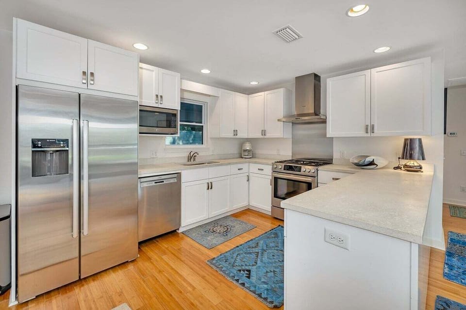 Kitchen with white cabinets and stainless appliances