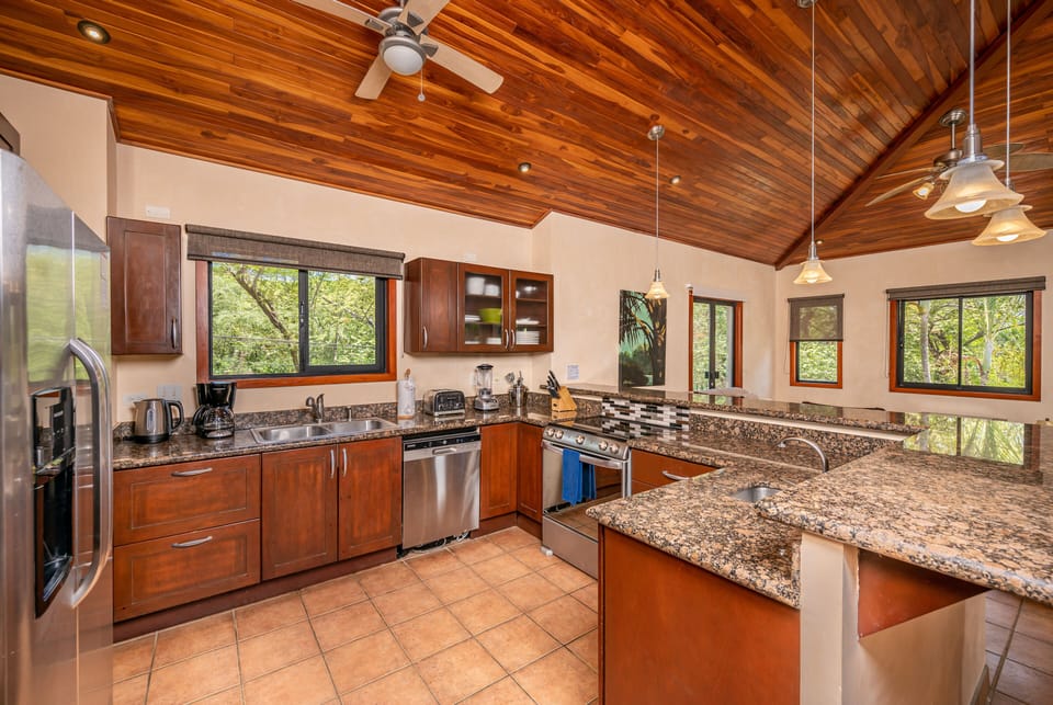 kitchen looking at great room - high vaulted teak ceilings