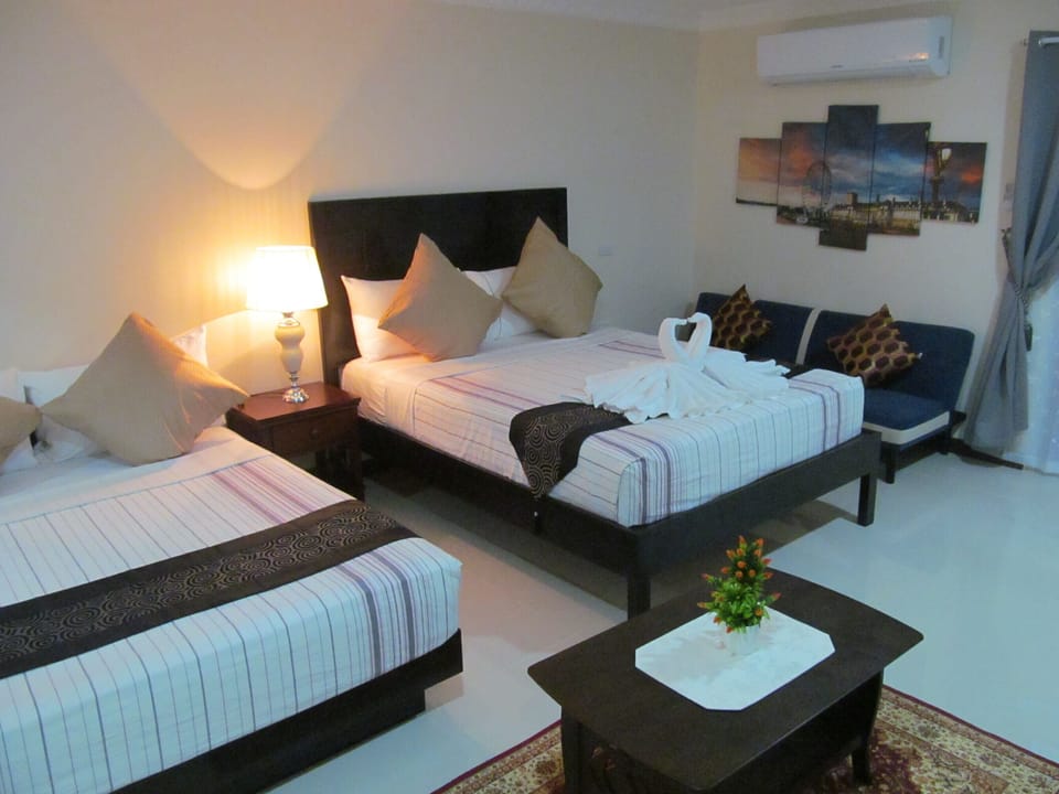 Deluxe Suite, 1 Bedroom, Kitchenette, Pool View | 1 bedroom, premium bedding, individually decorated