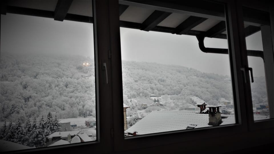 Attic, view of the snowy Collina D'Oro (Golden Hill)