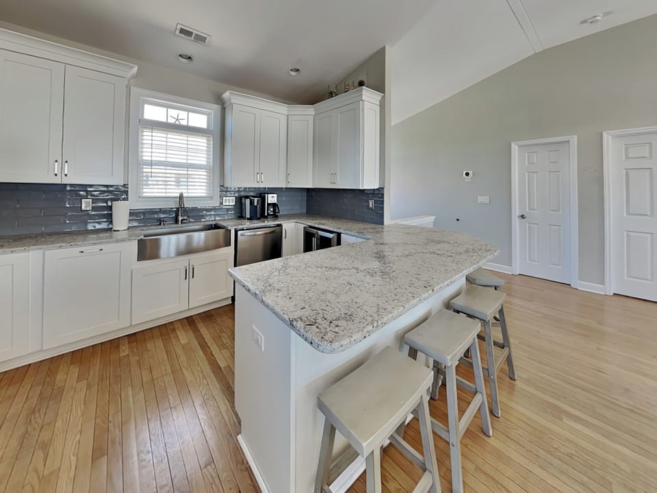 Fully Equipped Kitchen + Breakfast Bar Seating for Five