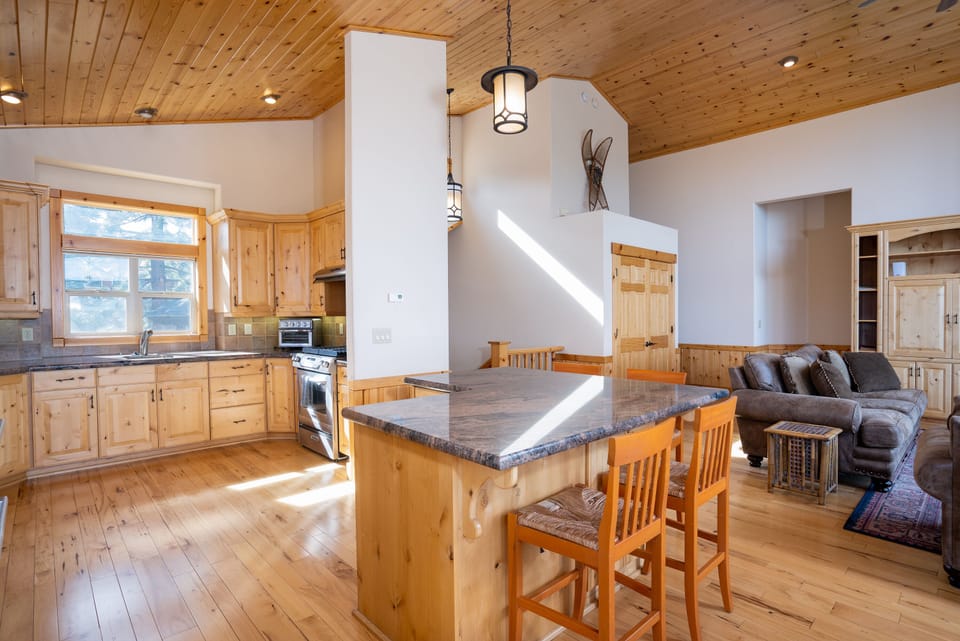 Step into the well-equipped kitchen that offers granite countertop and beautiful pine cabinetry, stainless steel appliances including a large french door refrigerator with bottom freezer, 2 sinks and a breakfast bar with seating for 4.