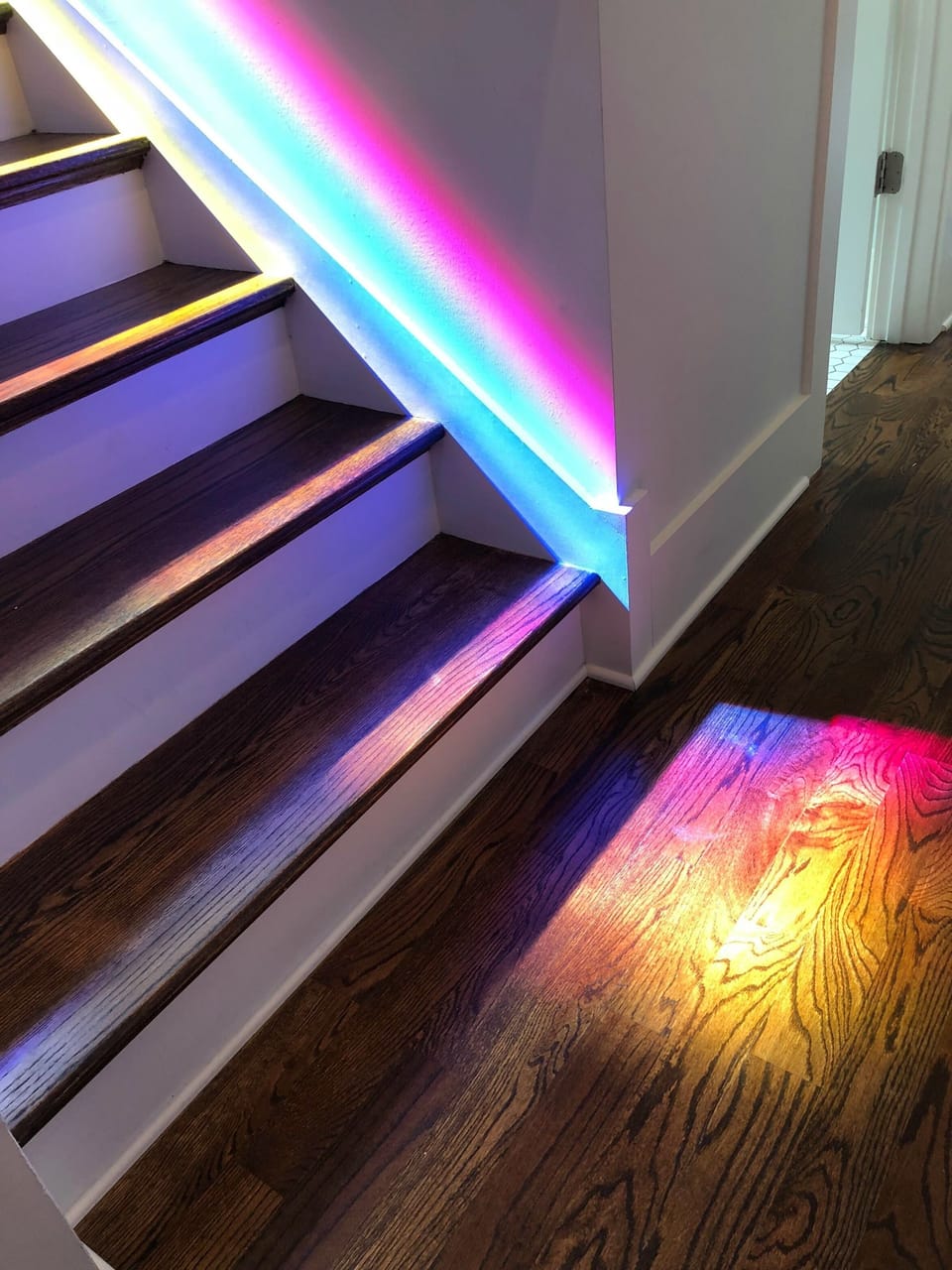 Gorgeous reflection of the custom stained window in stairway!