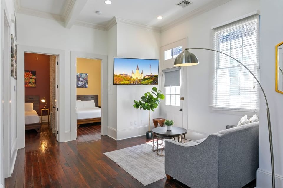 Part of the living room and doors heading to 2 bedrooms