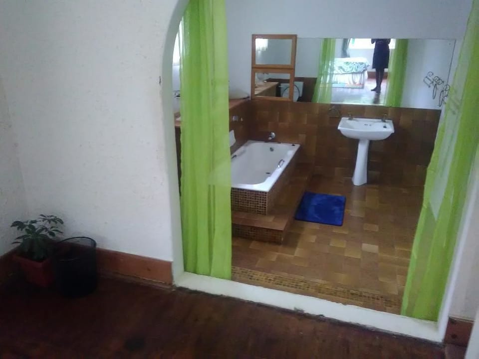 Economy Double Room | Bathroom | Combined shower/tub, deep soaking tub, rainfall showerhead