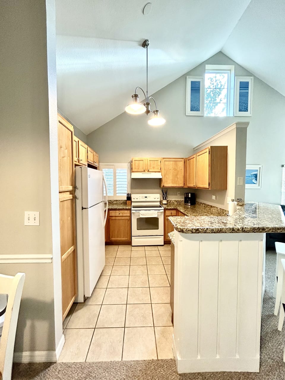 Fully equipped kitchen with cookware, utensils, cups, plates, microwave, toaster
