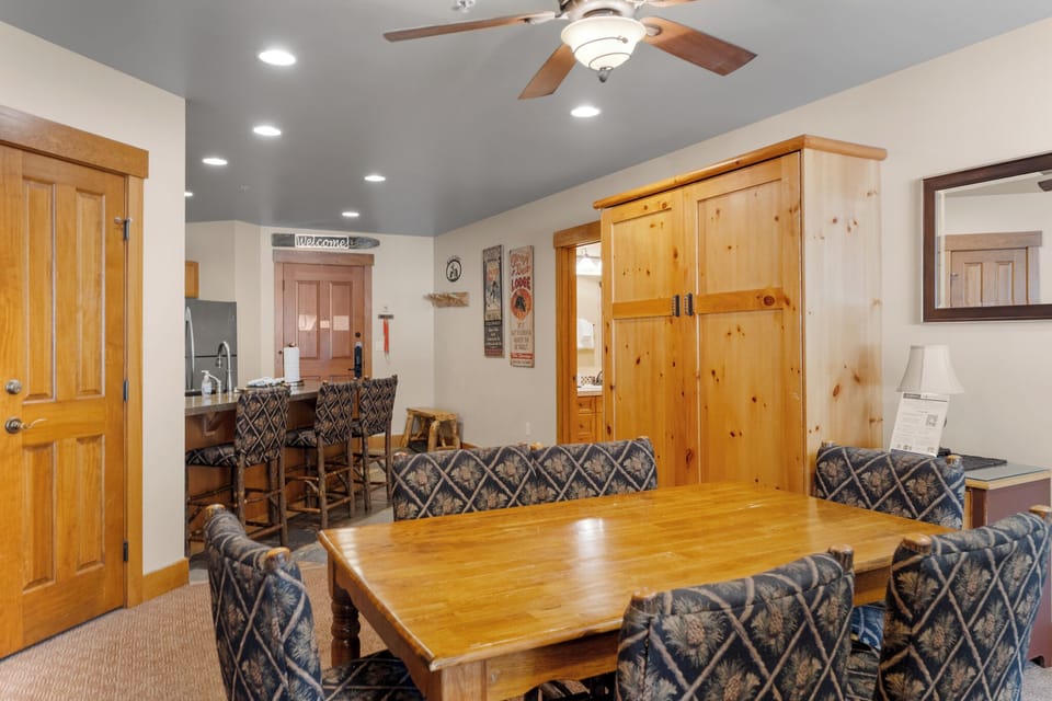 Gather around your spacious dining table where warm wood and comfortable seating create the perfect space for memorable meals together.