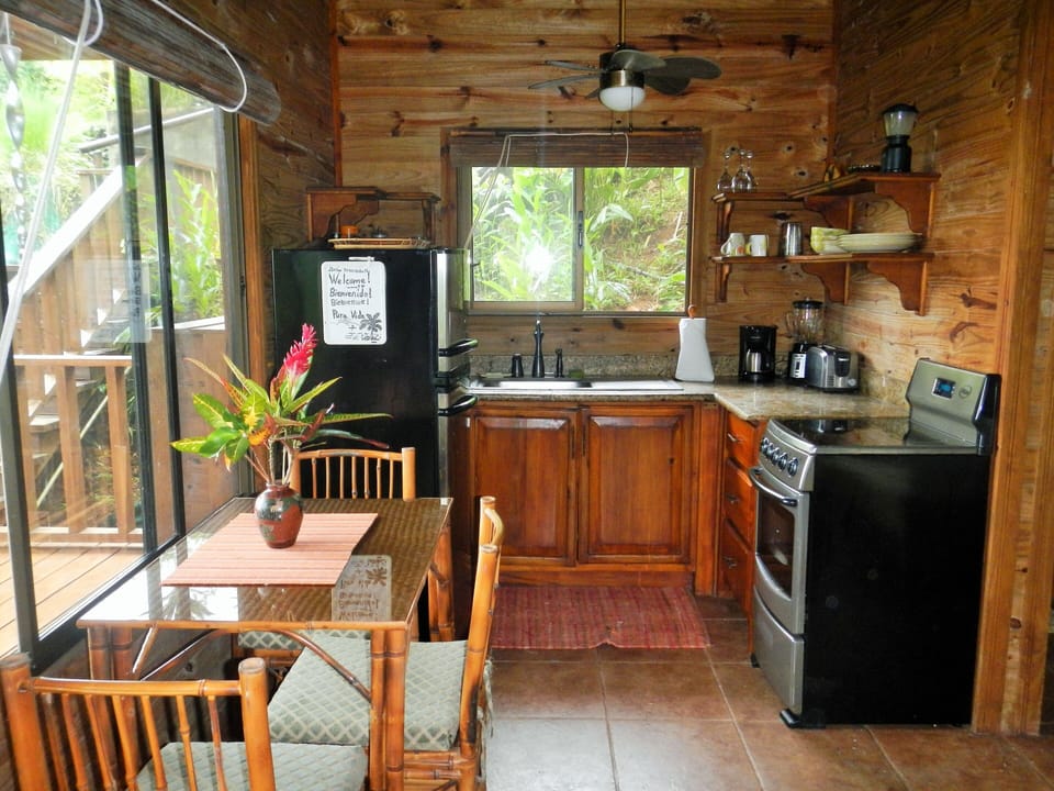 Kitchen has table and chairs in eating area