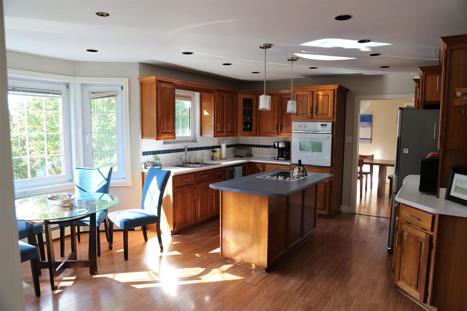 Large kitchen with beautiful sunlit lighting.