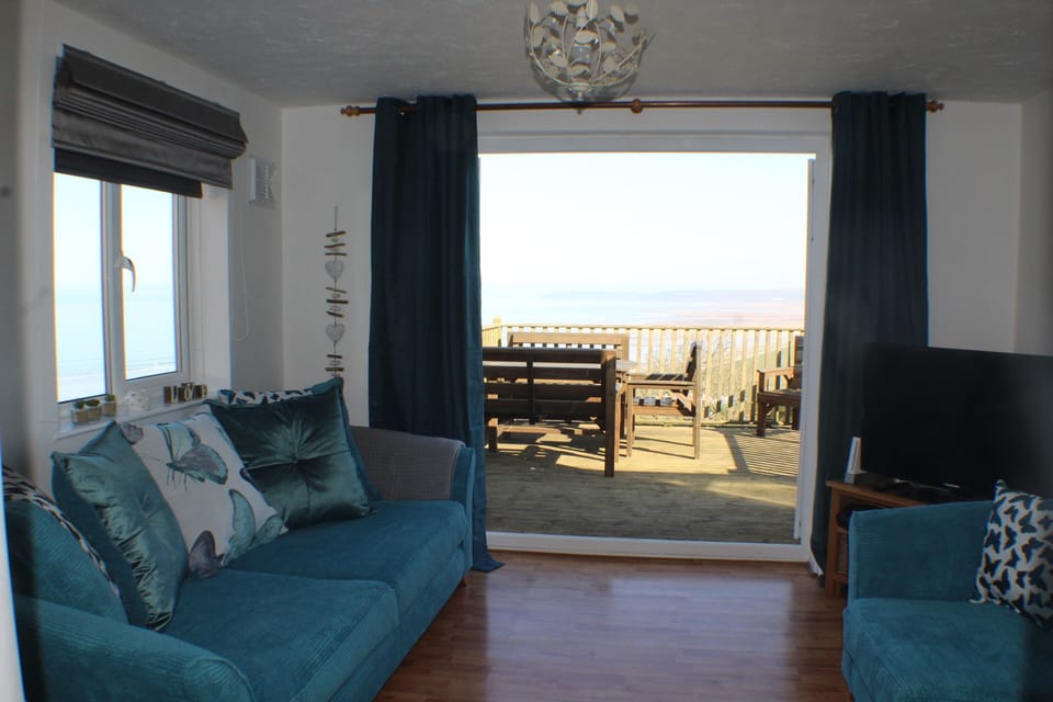 lounge leading to sun deck with sea views