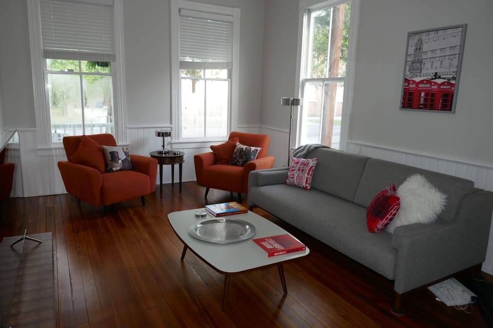Living room looking out to the Park.  Refinished wood floors. AC  & fan. IPTV