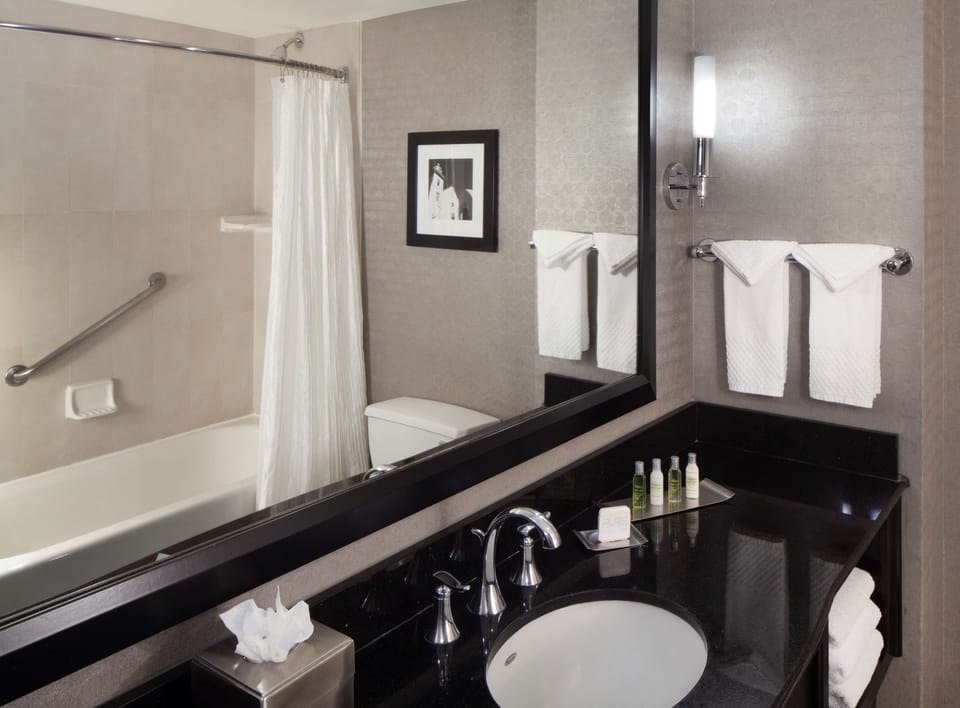 Combined shower/tub, designer toiletries, hair dryer, towels
