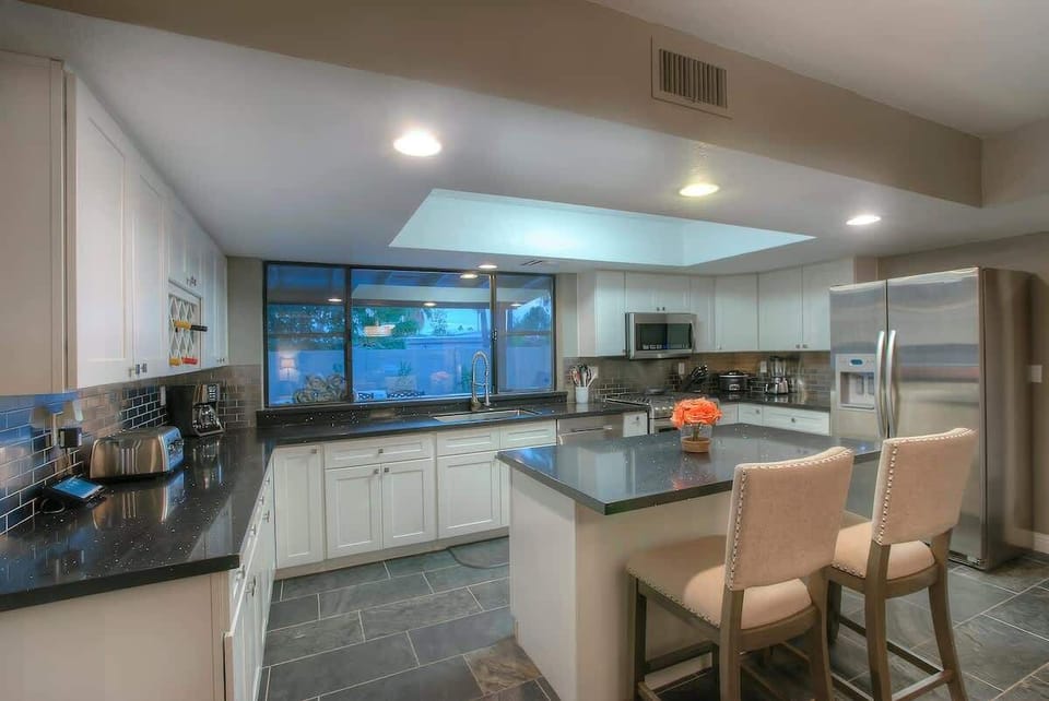 Spacious modern kitchen with stainless appliances and ample counter space.