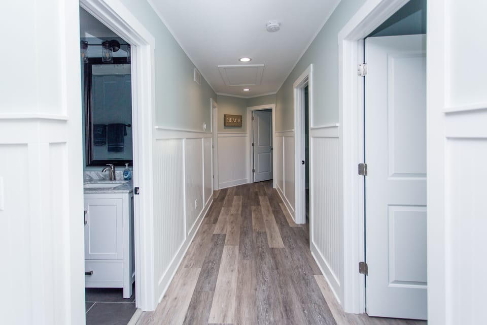Hallway of the upstairs with 4 bedrooms and 3 full baths. 