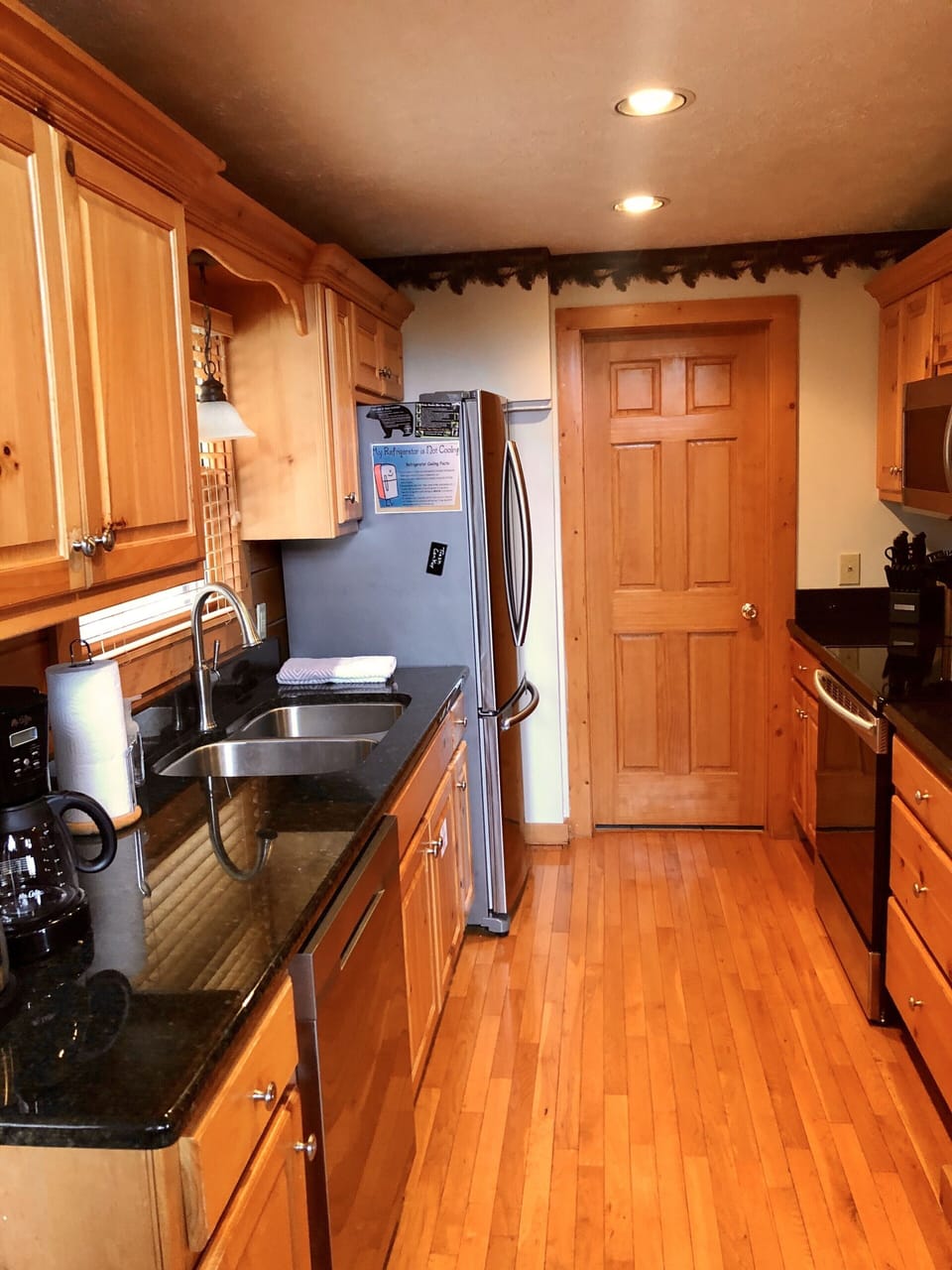 Galley style kitchen with all new stainless steel appliances.