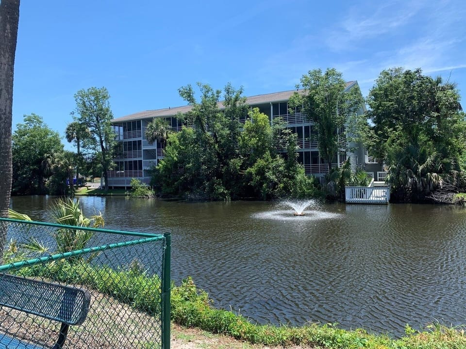 Back of building faces pond