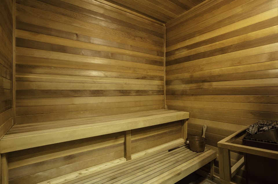 Step into your own private sauna, where smooth wooden benches and soothing warmth invite you to unwind. Let the gentle heat melt away tension as you breathe in the calming scent of natural wood.