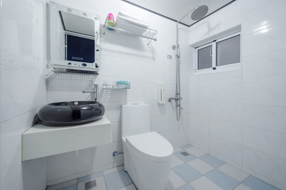 Four-person room in the building | Bathroom | Shower, rainfall showerhead, hair dryer, slippers