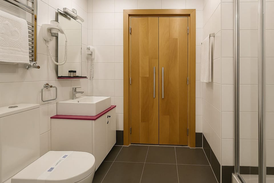 Shower, designer toiletries, hair dryer, slippers