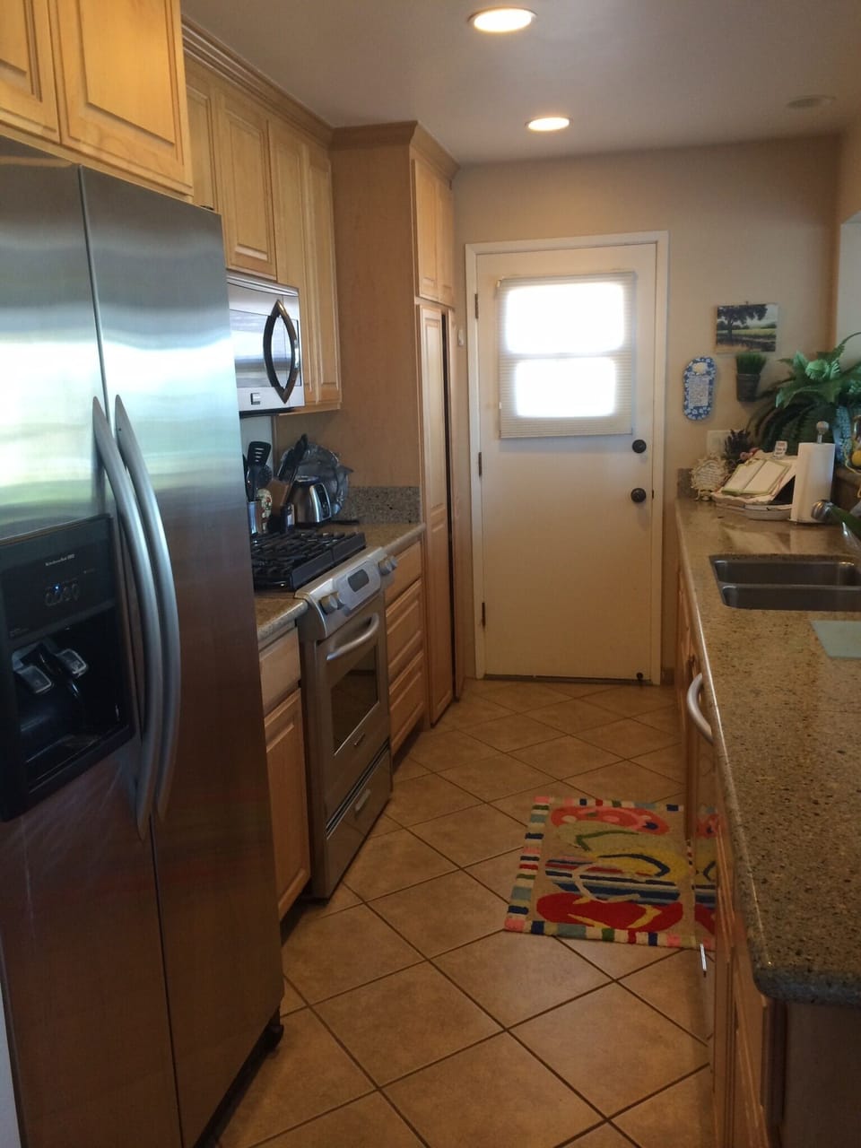 Kitchen with Kitchen Aid appliances.  Stackable washer & dryer (Boshe) on left 