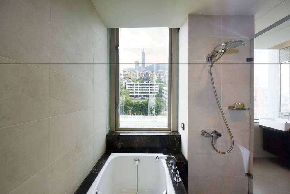 Separate tub and shower, hair dryer, slippers, bidet