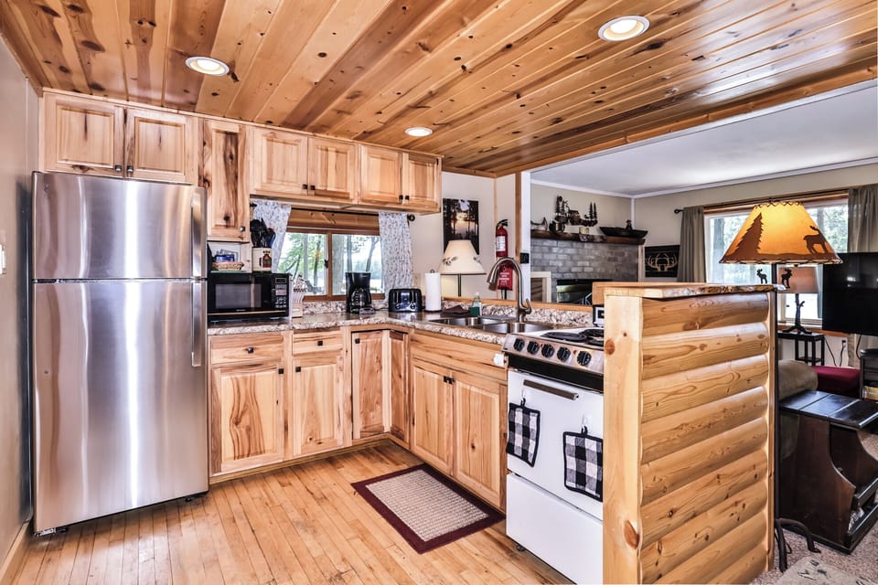 Rich wooden cabinetry & ceiling create rustic ambiance.