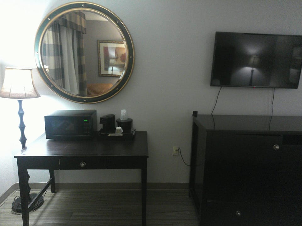 Desk, laptop workspace, blackout drapes, iron/ironing board