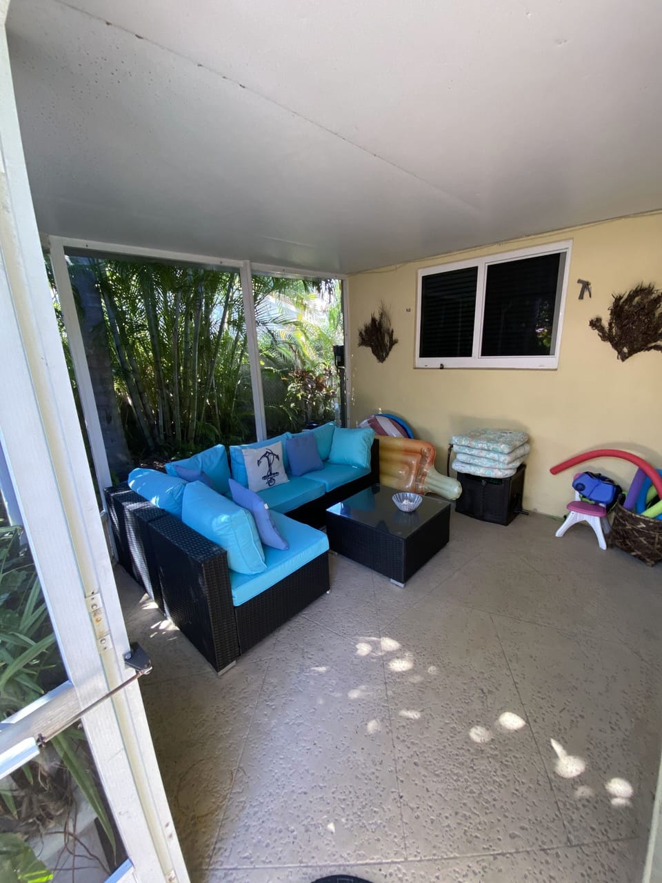 Screen patio with pool toys for kids